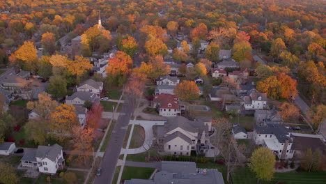 Aerial-pull-down-street-in-Kirkwood,-Missouri-neighborhood-in-Autumn-at-golden-hour,-second-half-of-two-clips