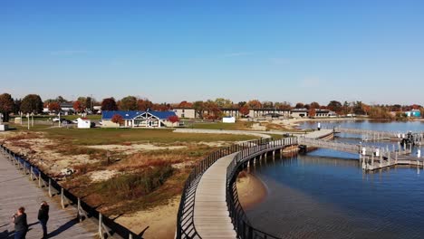 a rising aerial establishing shot of harbor park marina on lake huron in the autumn season