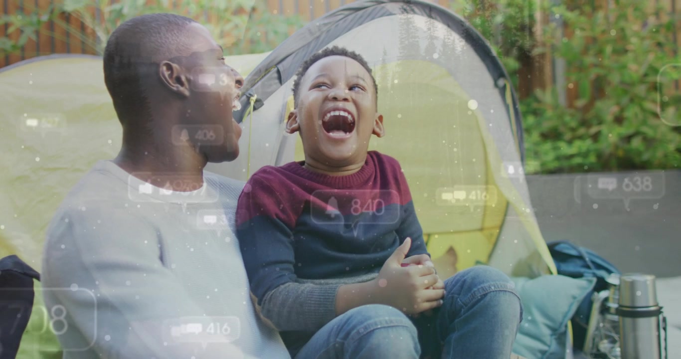 Dad and son laughing, clapping on patio dad making playful sound sparking family overlays for fun