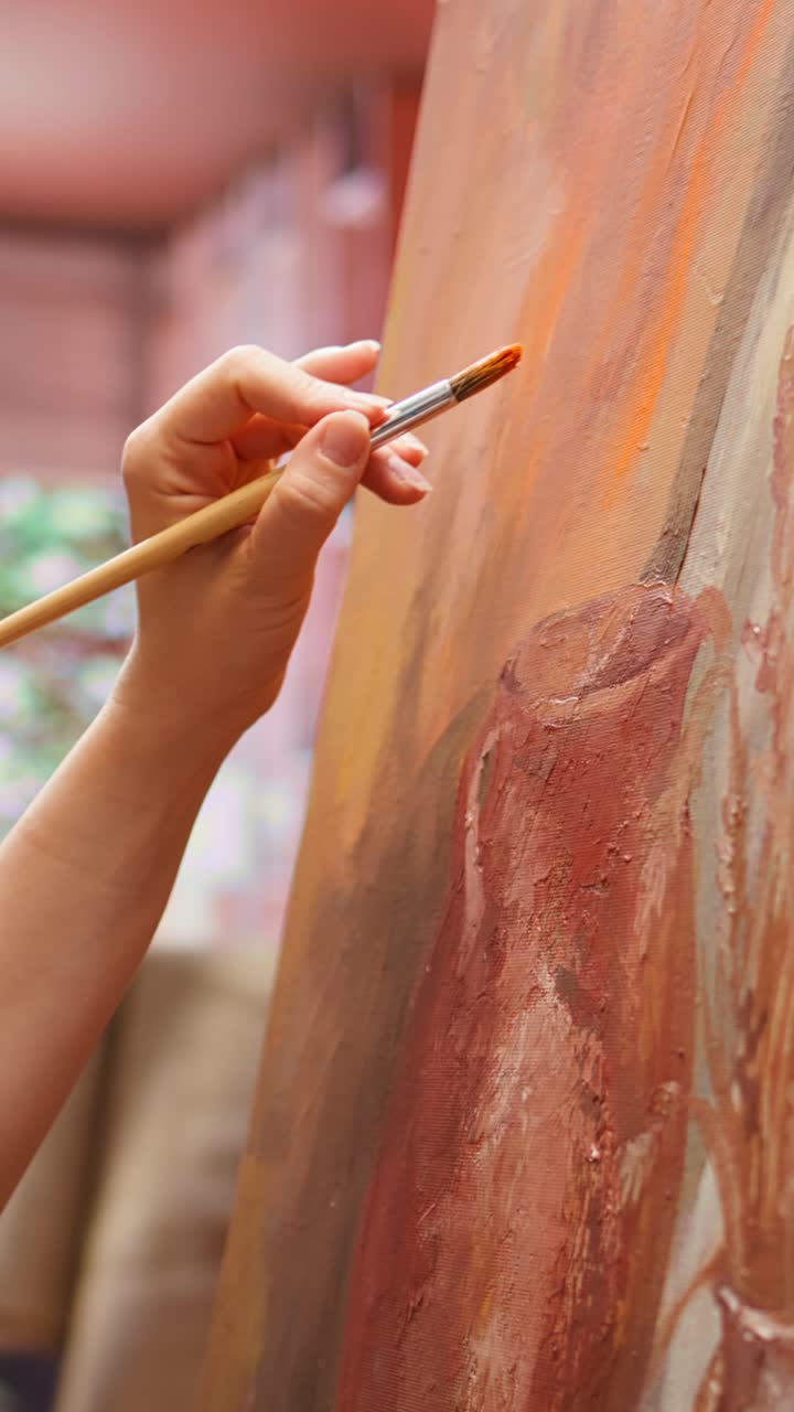 Close-up of Artist's Hand Painting on Canvas with a Brush