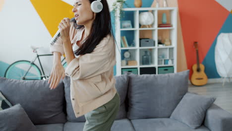 woman singing and dancing at home