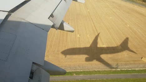 jet airplane landing shadow on the ground