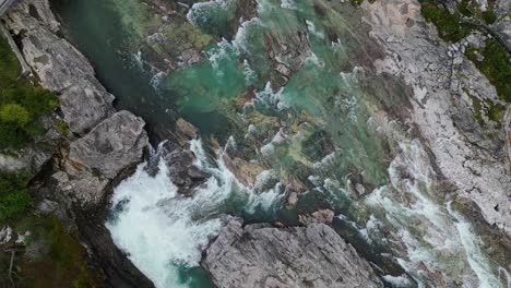 aerial over the river flowing over the rocks near donnfossen, nordberg, norway