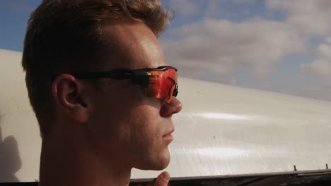 male rower wearing sunglasses looking away