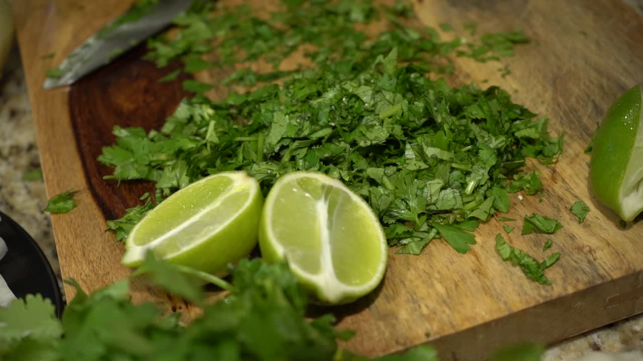 Chopped Cilantro and Limes on a Cutting Board