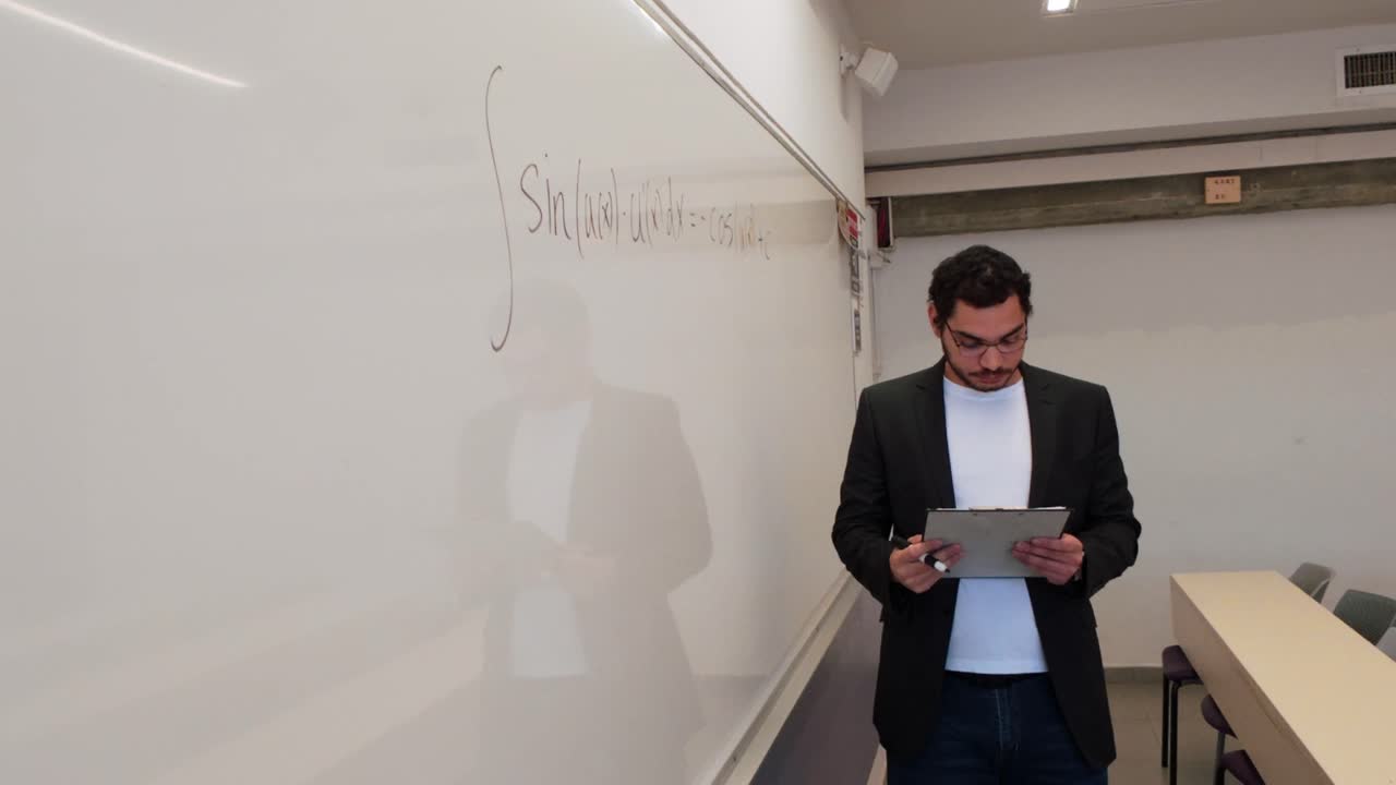 Man Writing a Formula in a Lecture Hall