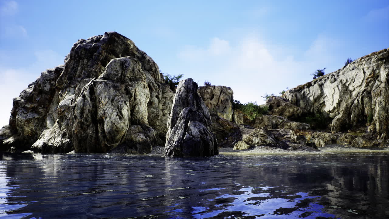 Majestic rocky coastline at sunrise with shimmering water reflections