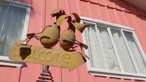 Decorative-crafts-from-metal-with-welcome-sign-in-country-house-garden