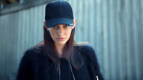 stylish girl looking at camera outdoors