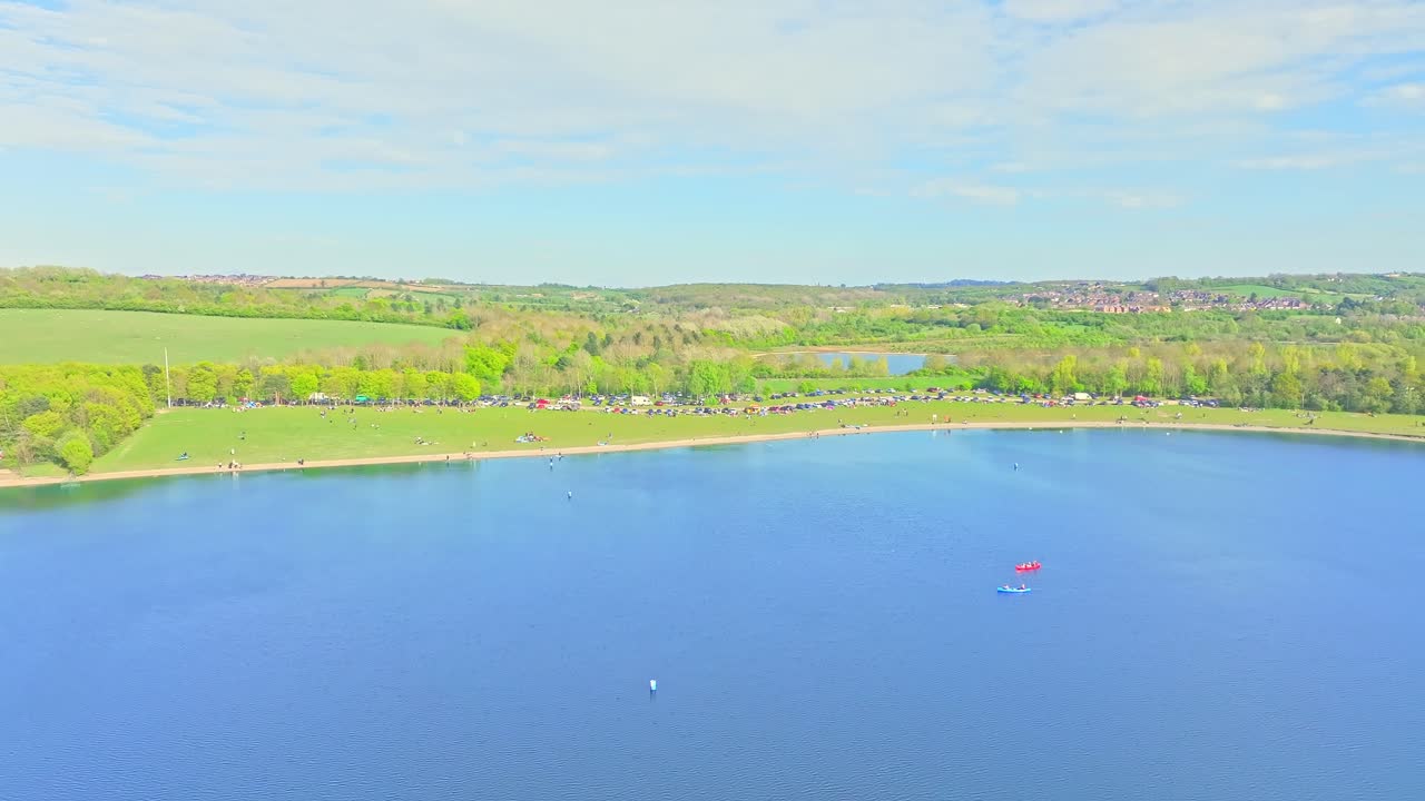 Crane up drone shot of lake during the day in Rother Valley Country Park in the Metropolitan Borough of Rotherham, South Yorkshire, England