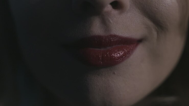 Primo piano della bocca di una donna con rossetto rosso