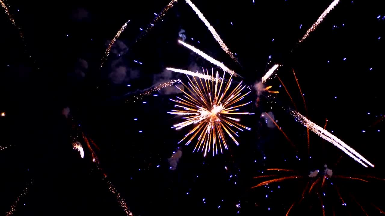Fireworks Flashing in the Night Sky. Slow Motion. Real Fireworks with Smoke