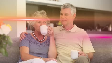 animation of light trails over caucasian couple drinking coffee