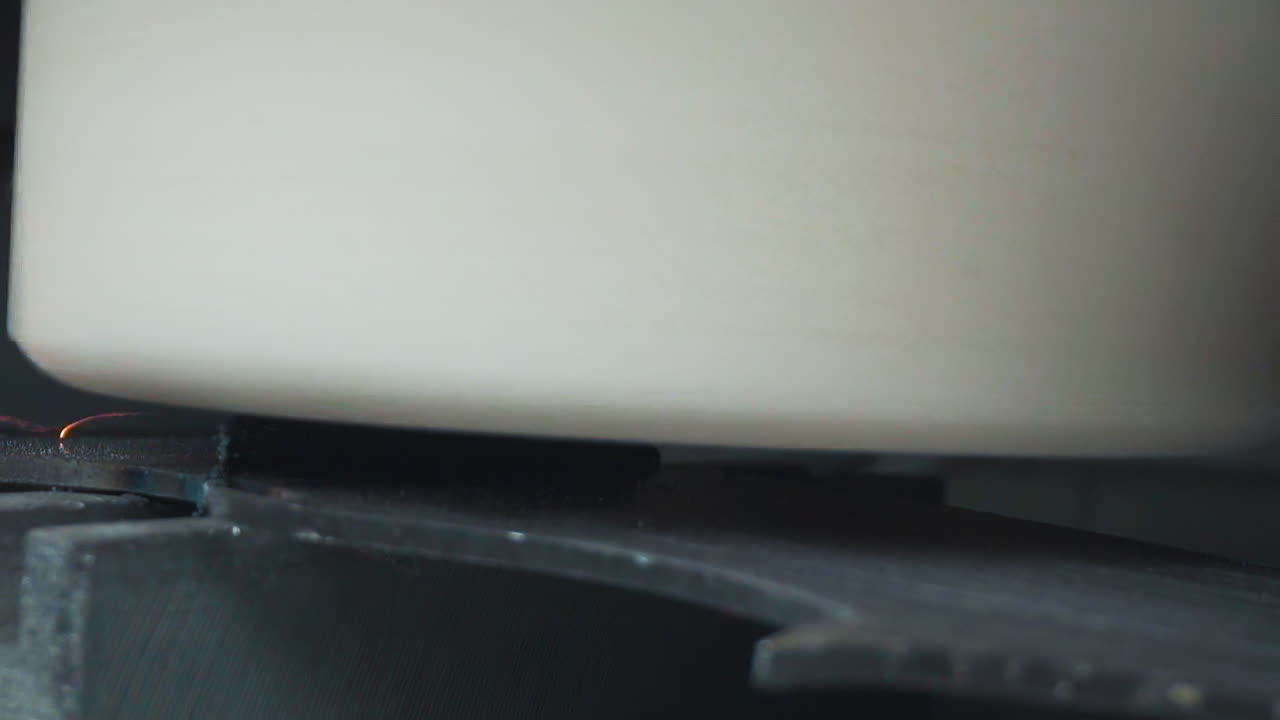 mechanism grinds weld seam on band saw in plant workshop