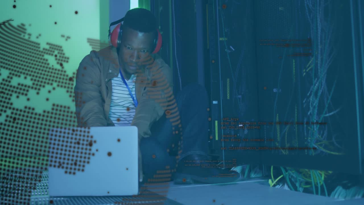 Male technician gazing at laptop and rack with map overlay appearing while typing network setup