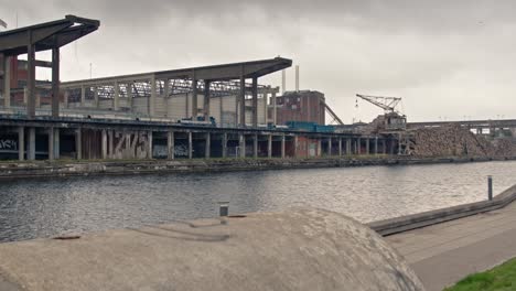 Slow-slider-sequence-of-old-rustic-industrial-pier-and-bulding-facade-with-an-old-crane-in-the-background