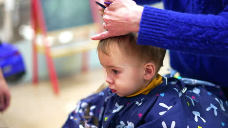 baby getting a haircut at a salon