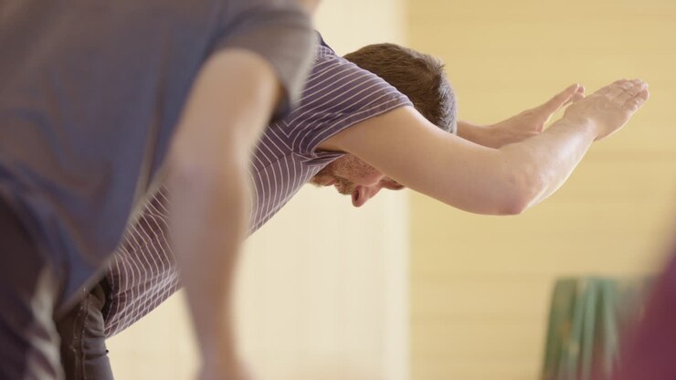 People practicing yoga in class