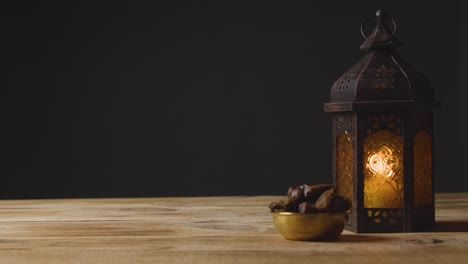 tracking shot of hand taking a drink of water on a table for ramadan