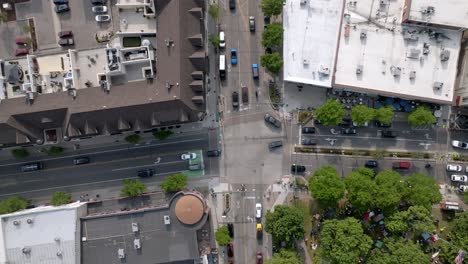 Intersection-in-downtown-Plymouth,-Michigan-with-drone-video-overhead-and-moving-down