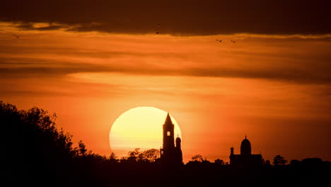 sunset silhouette of church and buildings