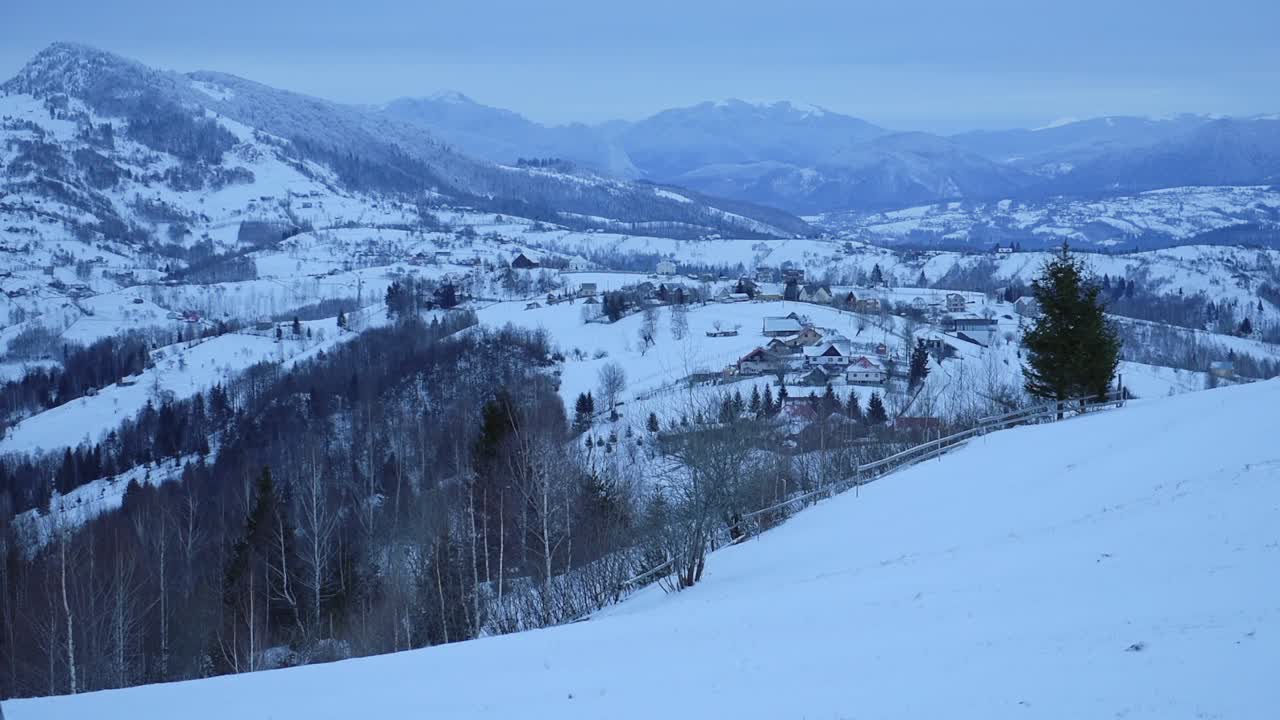 Snowy mountains landscape view, near Bran town, Romania, on a cold and cloudy evening