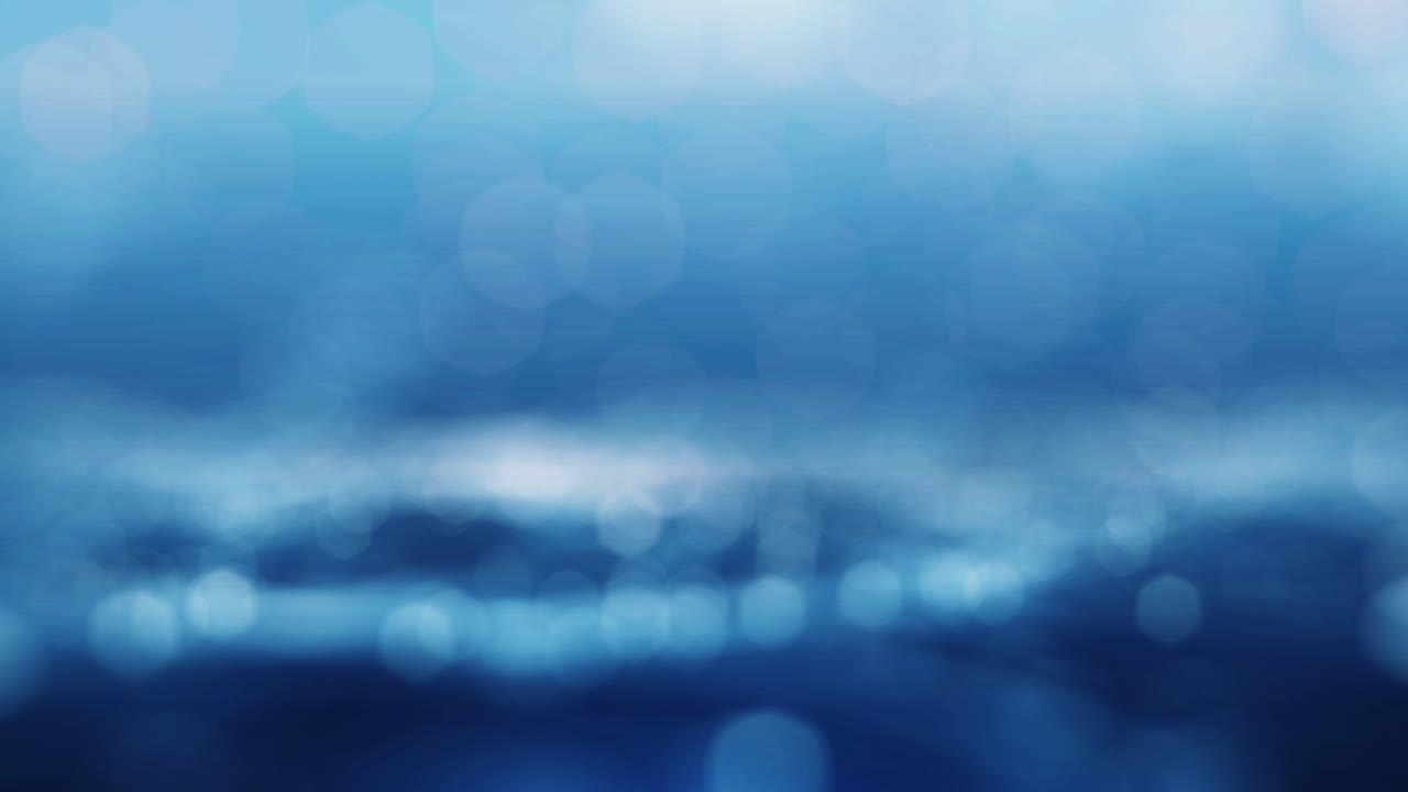 천천히 움직이는 추상적인 흐릿한 하 보케와 파란색 배경.