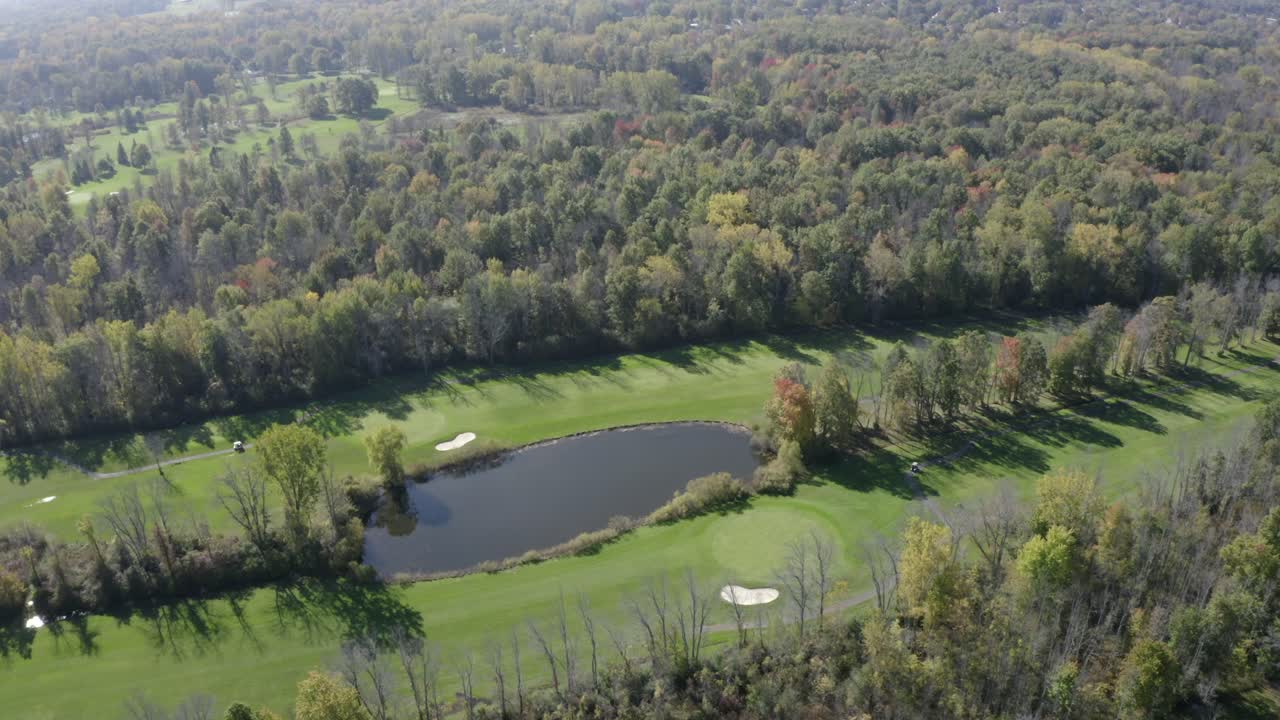 Drone footage of Golf Course. This is one clip of many in this series - each of which shows a different angle of the golf course and slightly different contents (greens - players) in the frame.