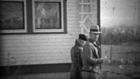 1933: proud couple walking new farm property recently purchased.