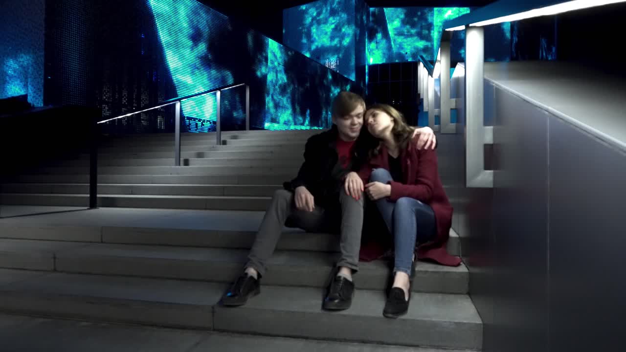пара сидит на лестнице ночью.
