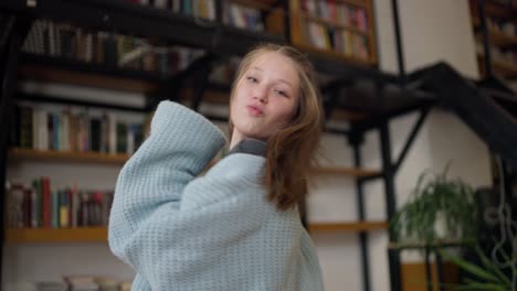 teenage girl dancing in a library
