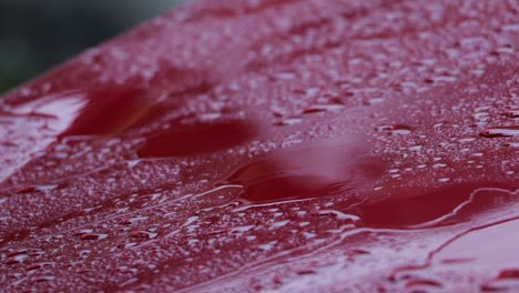 raindrops on the red car surface