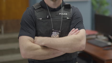 police officer in precinct crossed arm detective