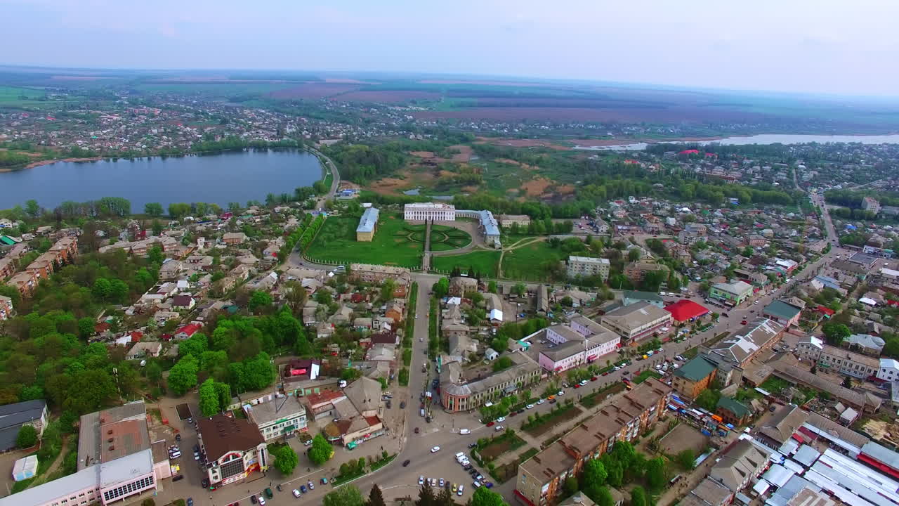 Scenery of usual Ukrainian town at daytime. Top view of the city locating near the river.