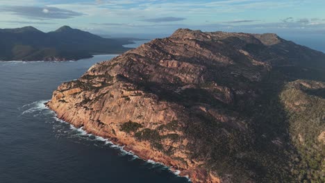 gigantic freycinet mountain at coles bay conservation area, tasmania during sunset time