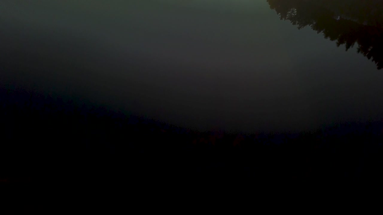 UHD drone reveal shot of a foggy sunrise over a lake and forest in cottage country canada