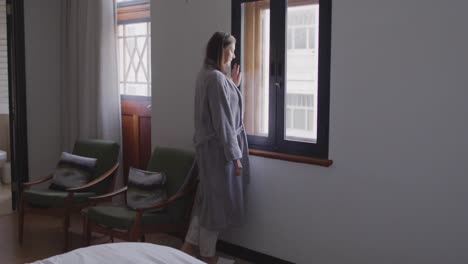 woman looking out of the window at home