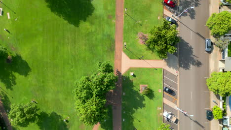 top down aerial drone shot of a cyclist on a footpath