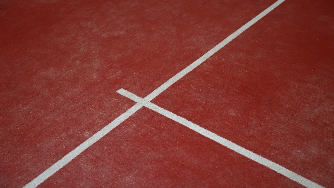 Clay tennis court lines create a simple sports setting