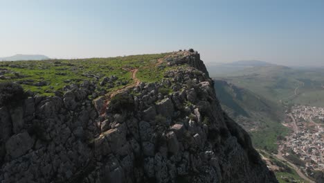 aerial view around the rocky mount arbel mountain, in sunny israel - circling, drone shot