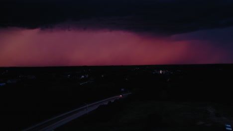 a lightning bolt strikes near a small town, highlighting the vulnerability of isolated communities in the face of extreme weather. minnesota, usa