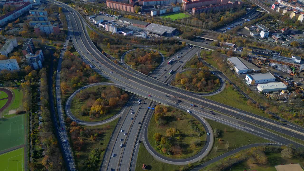 Complex urban highway freeway interchange with cars traversing roads in Berlin. Wonderful aerial view flight top down drone view