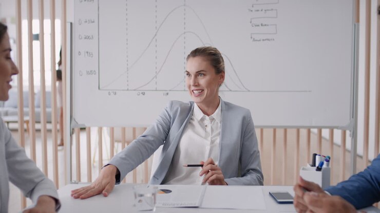 beautiful business woman team leader meeting with colleagues sharing creative ideas for startup project discussing corporate strategy in office boardroom