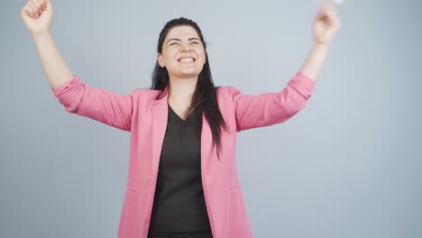 business woman looks at the document in her hand and rejoices.