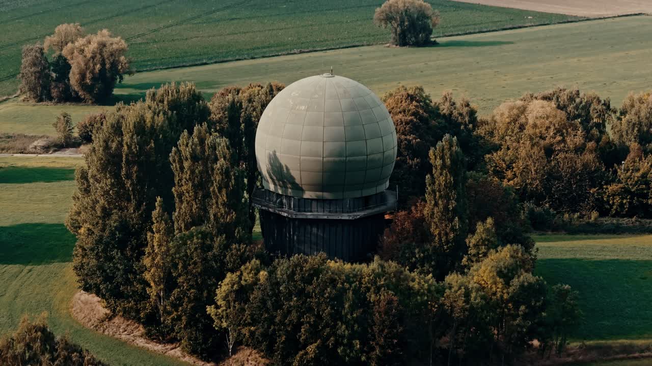 Aerial View of a Large Radar Dome Surrounded by Trees and Fields