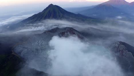 clouds over ijen volcano complex, sunrise over prehistoric-like landscape