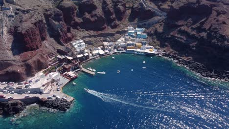 aerial drone video of beautiful bay of ammoudi below picturesque village of oia, cyclades, greece