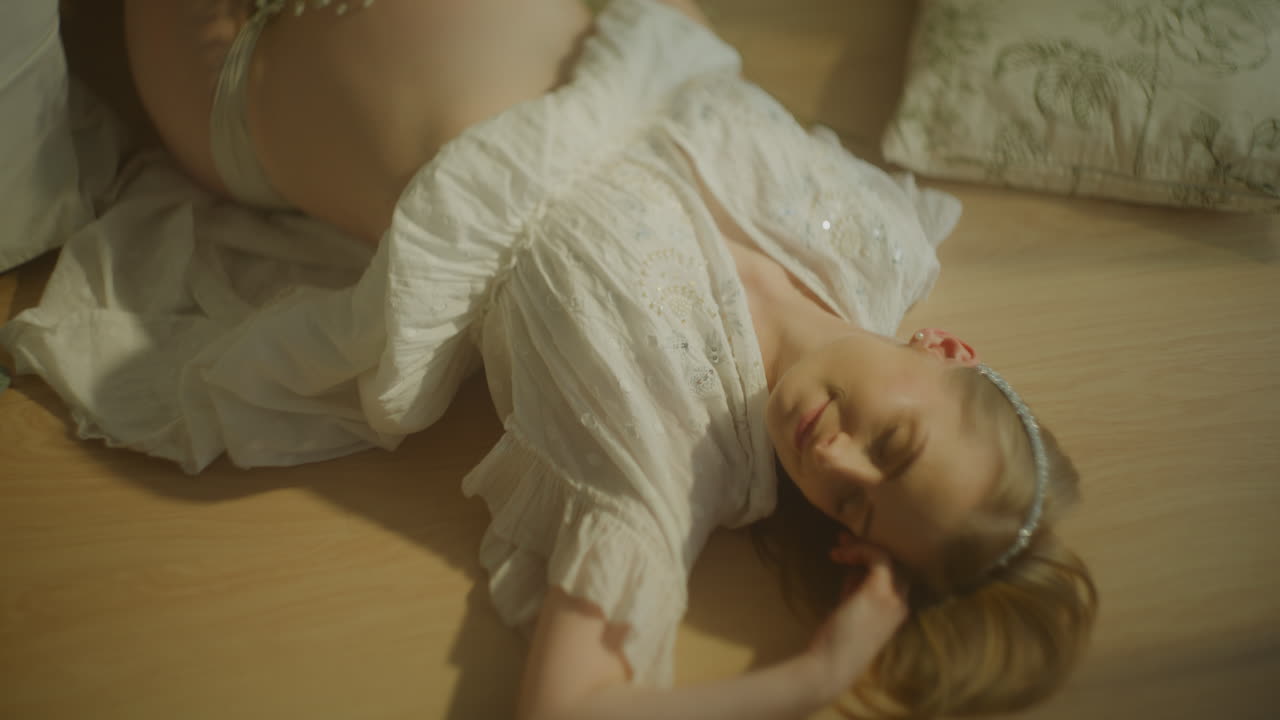 Pensive Woman Sunlit on Floor