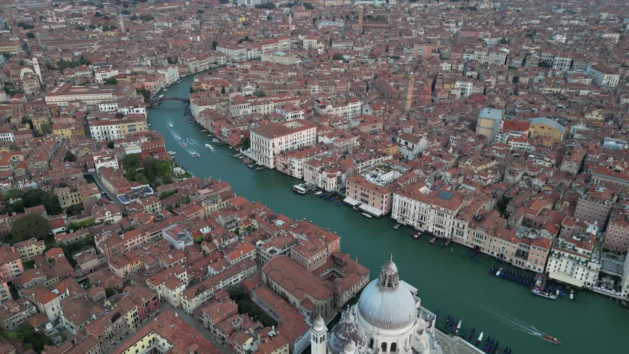 High-angle aerial view of the Grand Canal winding through Venice’s historic buildings.