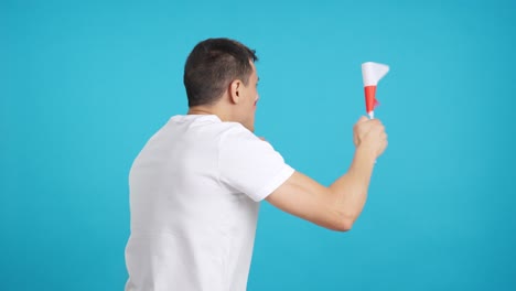 Rear view of a man waving a polish pennant